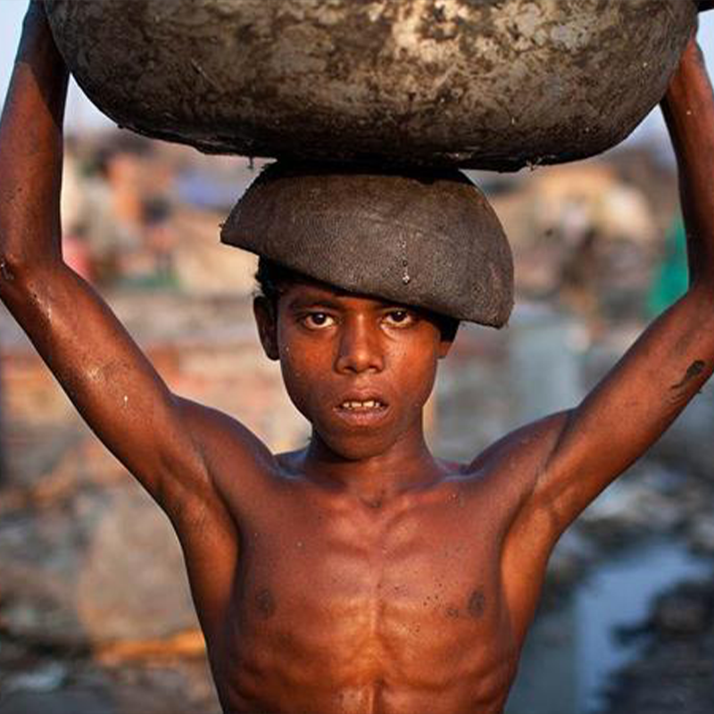 Child labour awareness - child carrying heavy load