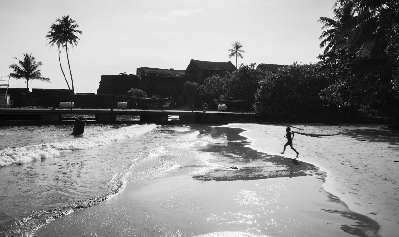 Child running near palm trees, Sri Lanka beach